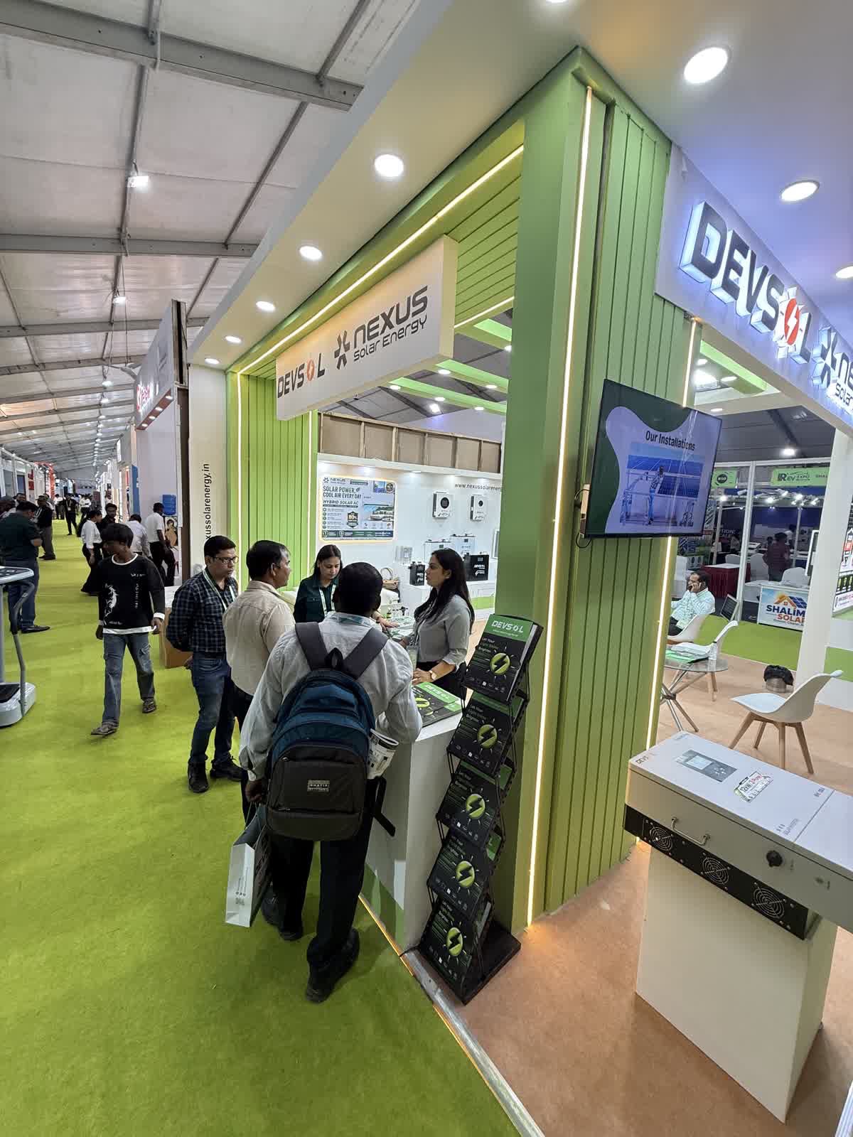 Visitors speaking with the Nexus Solar Energy team at the stall B41 counter, REV Expo Lucknow 2026