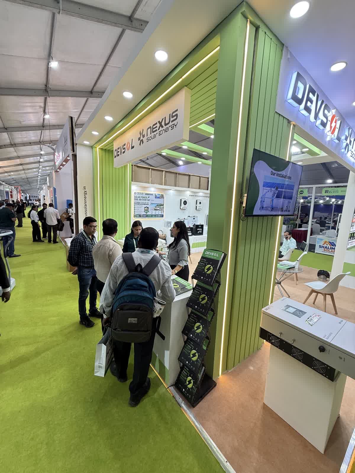 Visitors and Nexus Solar Energy team at the stall B41 counter, second angle, REV Expo Lucknow 2026